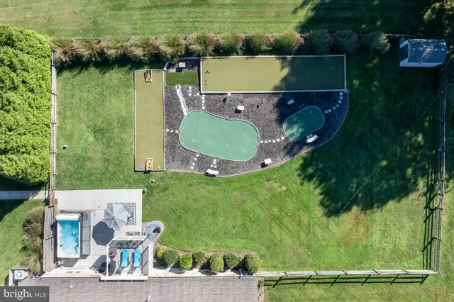 an aerial view of a house with a yard and lake view