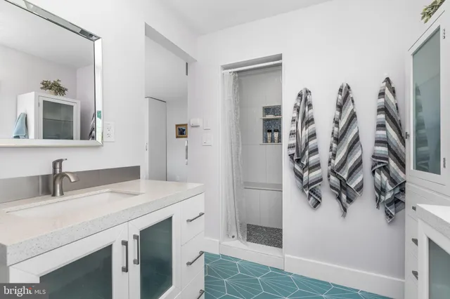 a bathroom with a sink vanity and a mirror