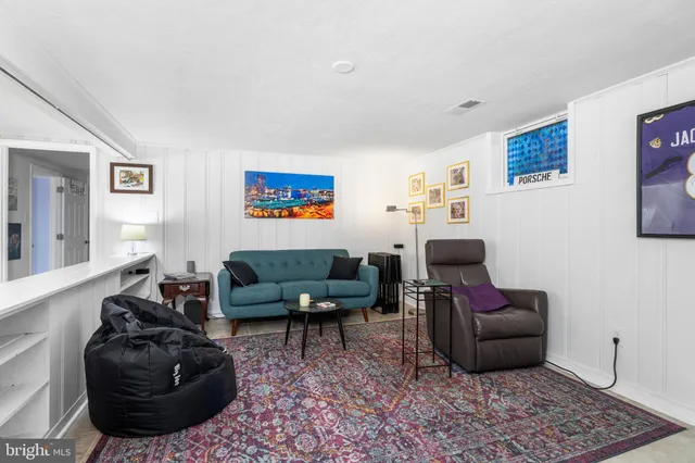 a living room with furniture rug and window