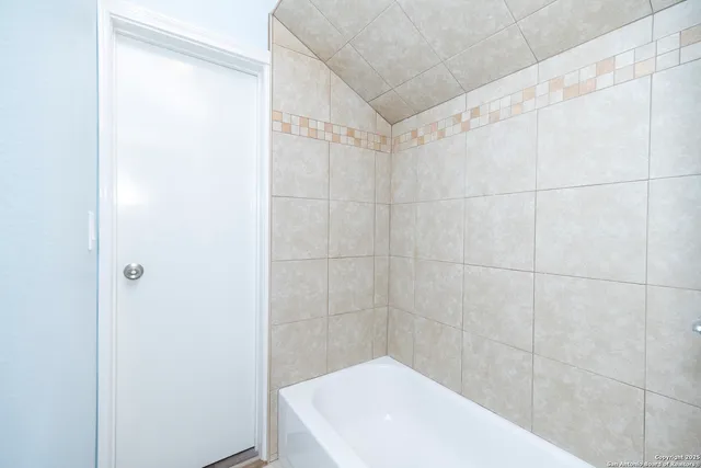 a bathroom with a shower and a sink