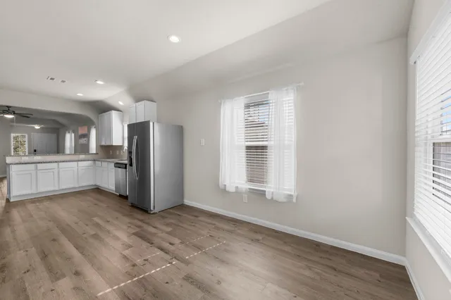 an empty room with windows and entrance