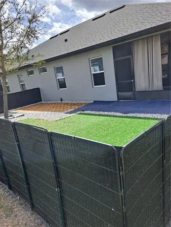 a view of a backyard with a barbeque grill and wooden floor