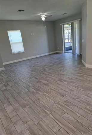 wooden floor in an empty room with a window