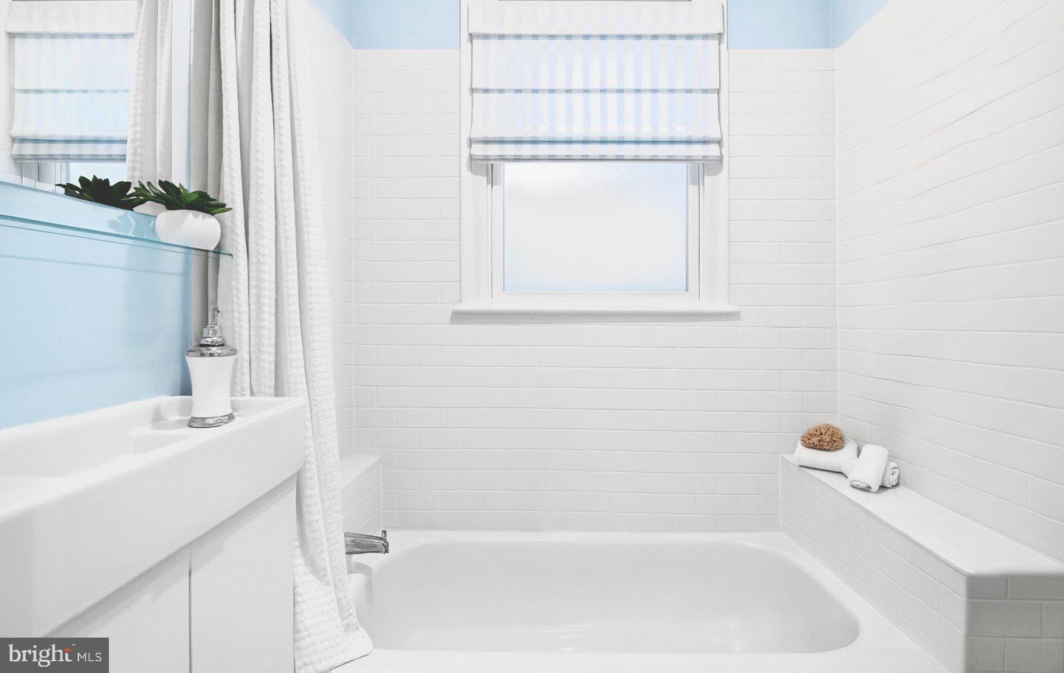 1627 Montello Avenue Northeast Washington, DC 20002 - Photo 9 of 17 a bathroom with a tub sink vanity and a mirror