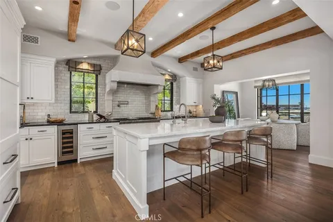 a kitchen with a table chairs stove and cabinets