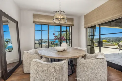 a kitchen with stainless steel appliances granite countertop a white cabinets and wooden floor