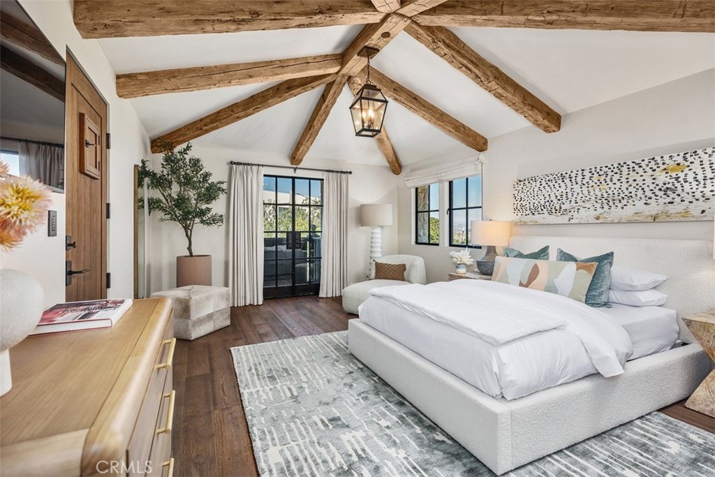 17 Pacific Ridge Place Dana Point, CA 92629 - Photo 22 of 47 a spacious bedroom with a large bed and a chandelier