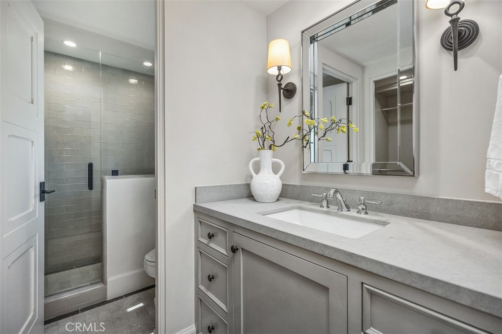 17 Pacific Ridge Place Dana Point, CA 92629 - Photo 25 of 47 a bathroom with a granite countertop sink a toilet and shower