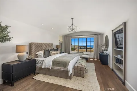 a bedroom with a bed and a television