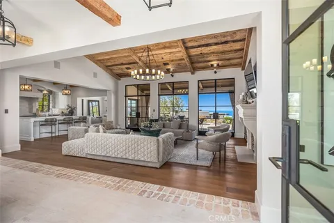 a living room with furniture chandelier and a fireplace