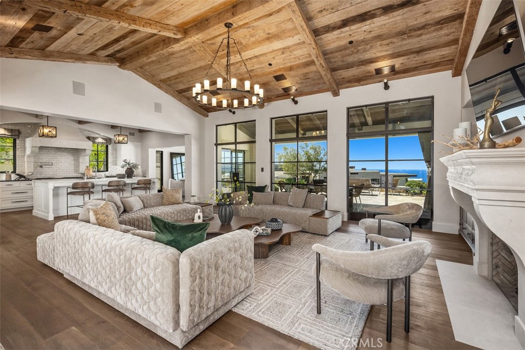 17 Pacific Ridge Place Dana Point, CA 92629 - Photo 9 of 47 a living room with furniture chandelier and a fireplace
