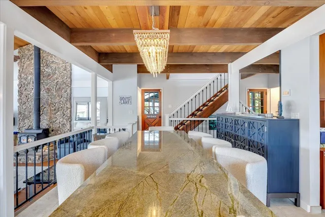 a bedroom with a bed a couch and a large window