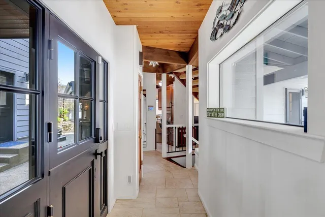 a spacious bedroom with a bed a flat screen tv and balcony view