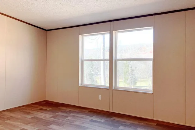 a bathroom with a granite countertop toilet a sink and a mirror