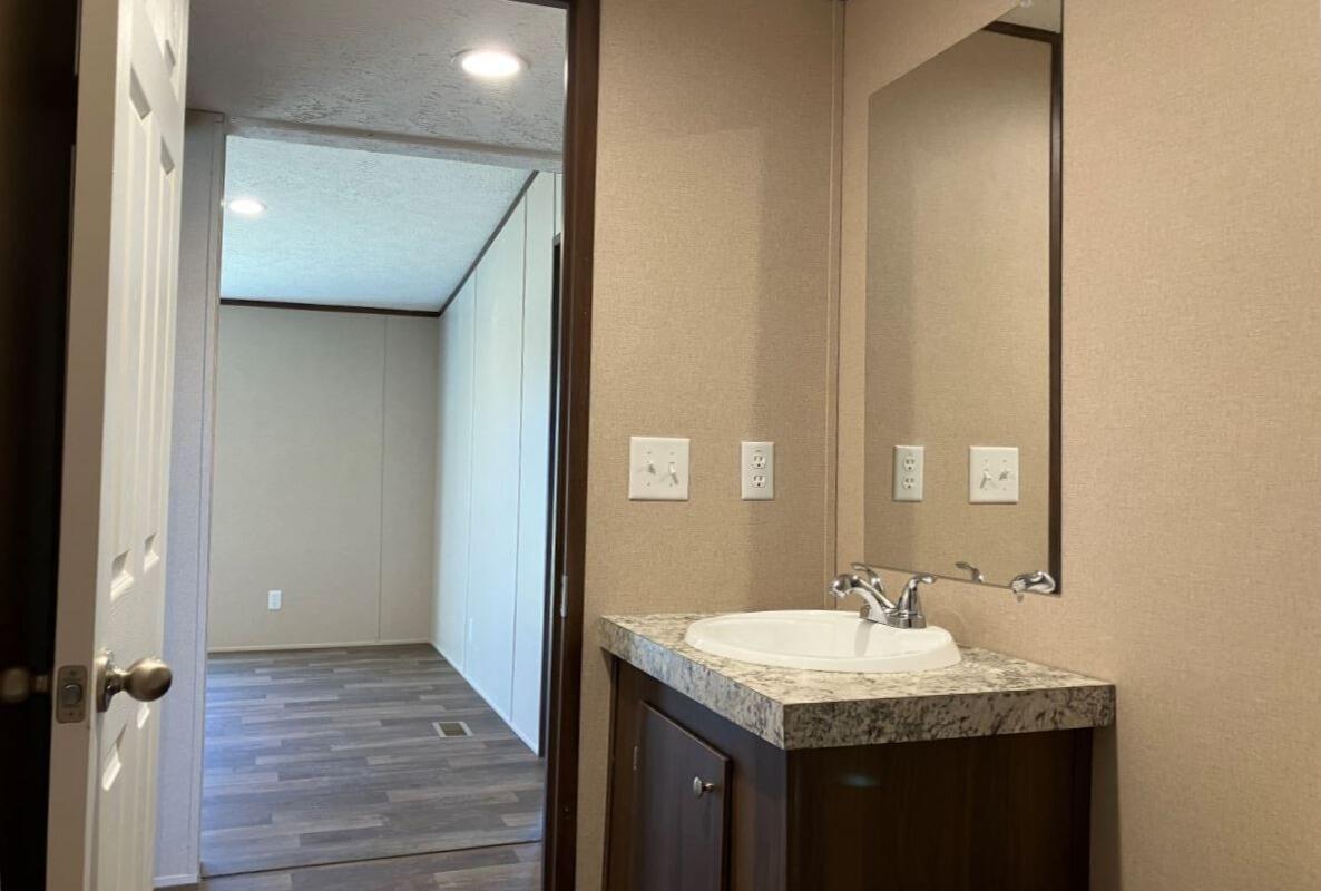 5489 Forge Road Glasgow, VA 24555 - Photo 20 of 38 a bathroom with a granite countertop sink and a mirror