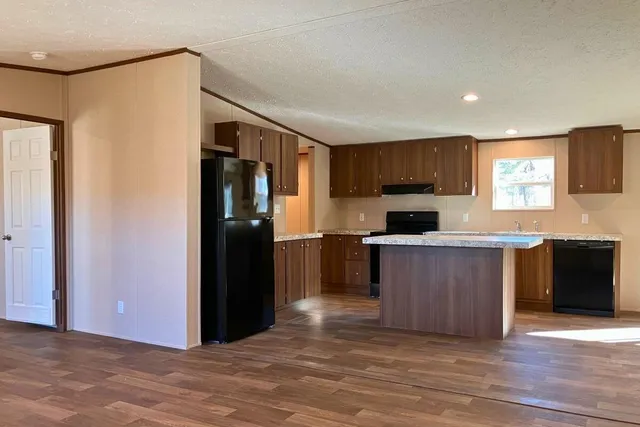 a view of a kitchen with a sink and cabinets