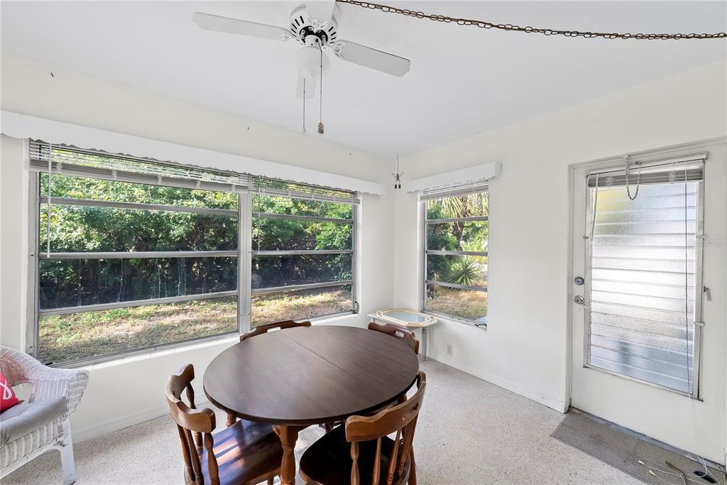 10609 Raffia Drive Port Richey, FL 34668 - Photo 11 of 24 a dining room with furniture and window
