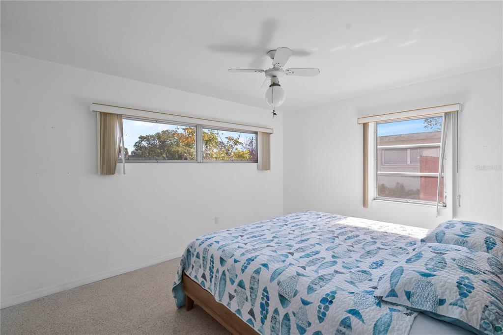 10609 Raffia Drive Port Richey, FL 34668 - Photo 13 of 24 a bedroom with a bed and a window