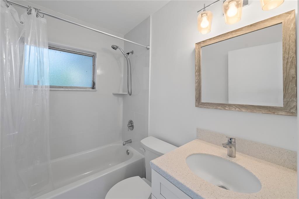10609 Raffia Drive Port Richey, FL 34668 - Photo 16 of 24 a bathroom with a sink toilet and shower