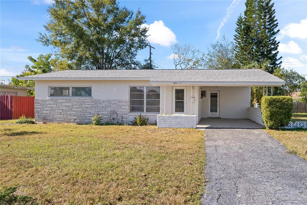 10609 Raffia Drive Port Richey, FL 34668 - Photo 2 of 24 front view of a house and a yard
