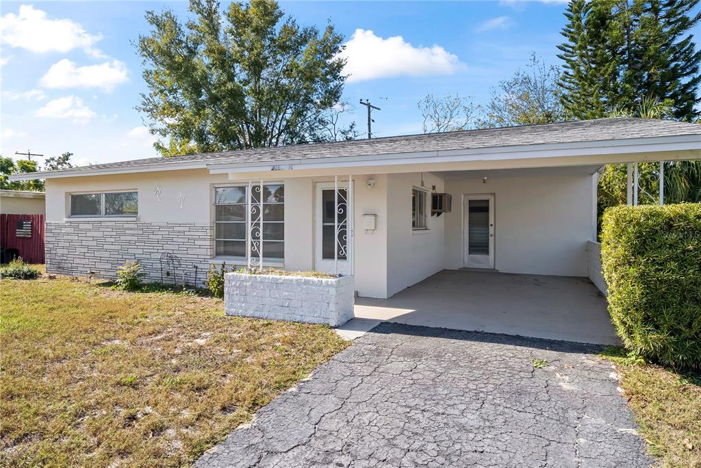 10609 Raffia Drive Port Richey, FL 34668 - Photo 24 of 24 a view of a house with a yard and potted plants