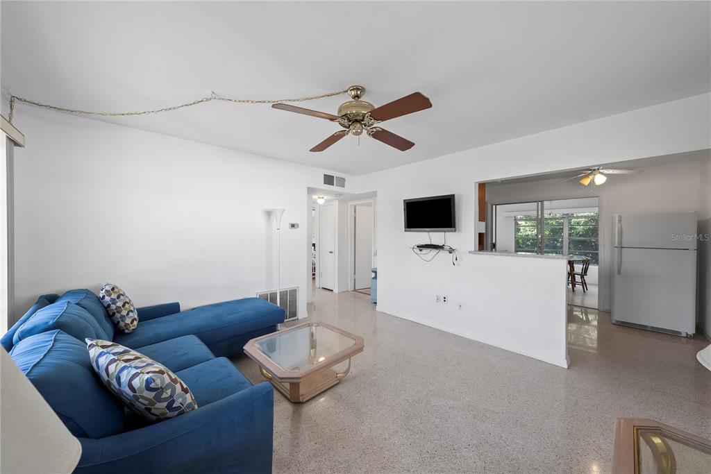 10609 Raffia Drive Port Richey, FL 34668 - Photo 3 of 24 a living room with furniture and a flat screen tv