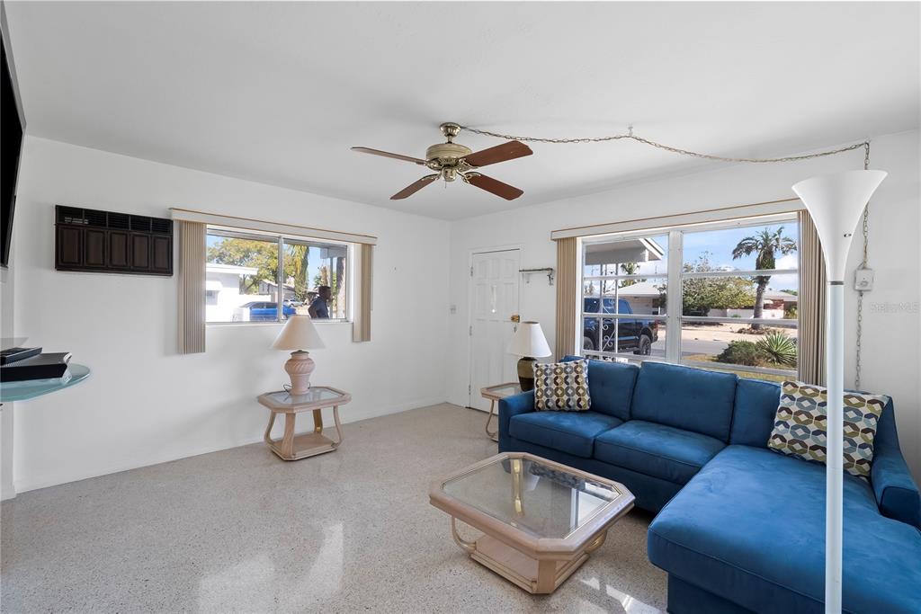 10609 Raffia Drive Port Richey, FL 34668 - Photo 5 of 24 a living room with furniture and a flat screen tv