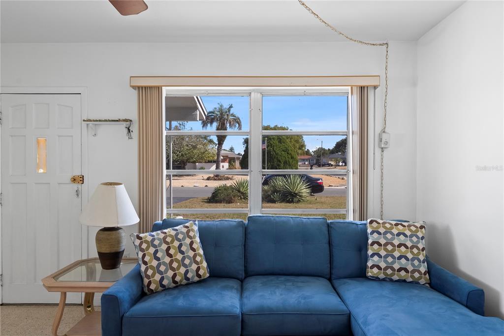 10609 Raffia Drive Port Richey, FL 34668 - Photo 6 of 24 a living room with furniture and a large window
