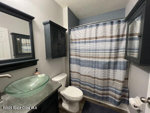 1015 Swiss Pointe Lane Rockledge, FL 32955 - Photo 13 of 26 a bathroom with a sink toilet and shower