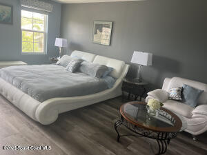1015 Swiss Pointe Lane Rockledge, FL 32955 - Photo 16 of 26 a bedroom with a bed and chair