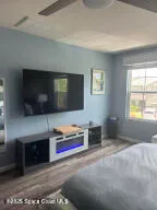 a living room with fireplace furniture and a flat screen tv