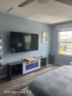 1015 Swiss Pointe Lane Rockledge, FL 32955 - Photo 17 of 26 a living room with fireplace furniture and a flat screen tv