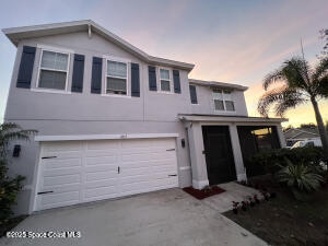 1015 Swiss Pointe Lane Rockledge, FL 32955 - Photo 2 of 26 a front view of a house with a yard