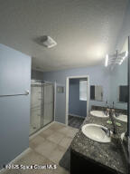 1015 Swiss Pointe Lane Rockledge, FL 32955 - Photo 25 of 26 a bathroom with a sink and a mirror