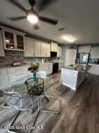 a kitchen with a stove a sink and a microwave