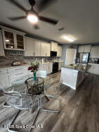 1015 Swiss Pointe Lane Rockledge, FL 32955 - Photo 4 of 26 a kitchen with a stove a sink and a microwave