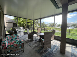 1015 Swiss Pointe Lane Rockledge, FL 32955 - Photo 10 of 26 a living room with furniture and a floor to ceiling window