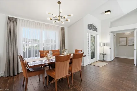 a view of a dining room with furniture wooden floor and chandelier