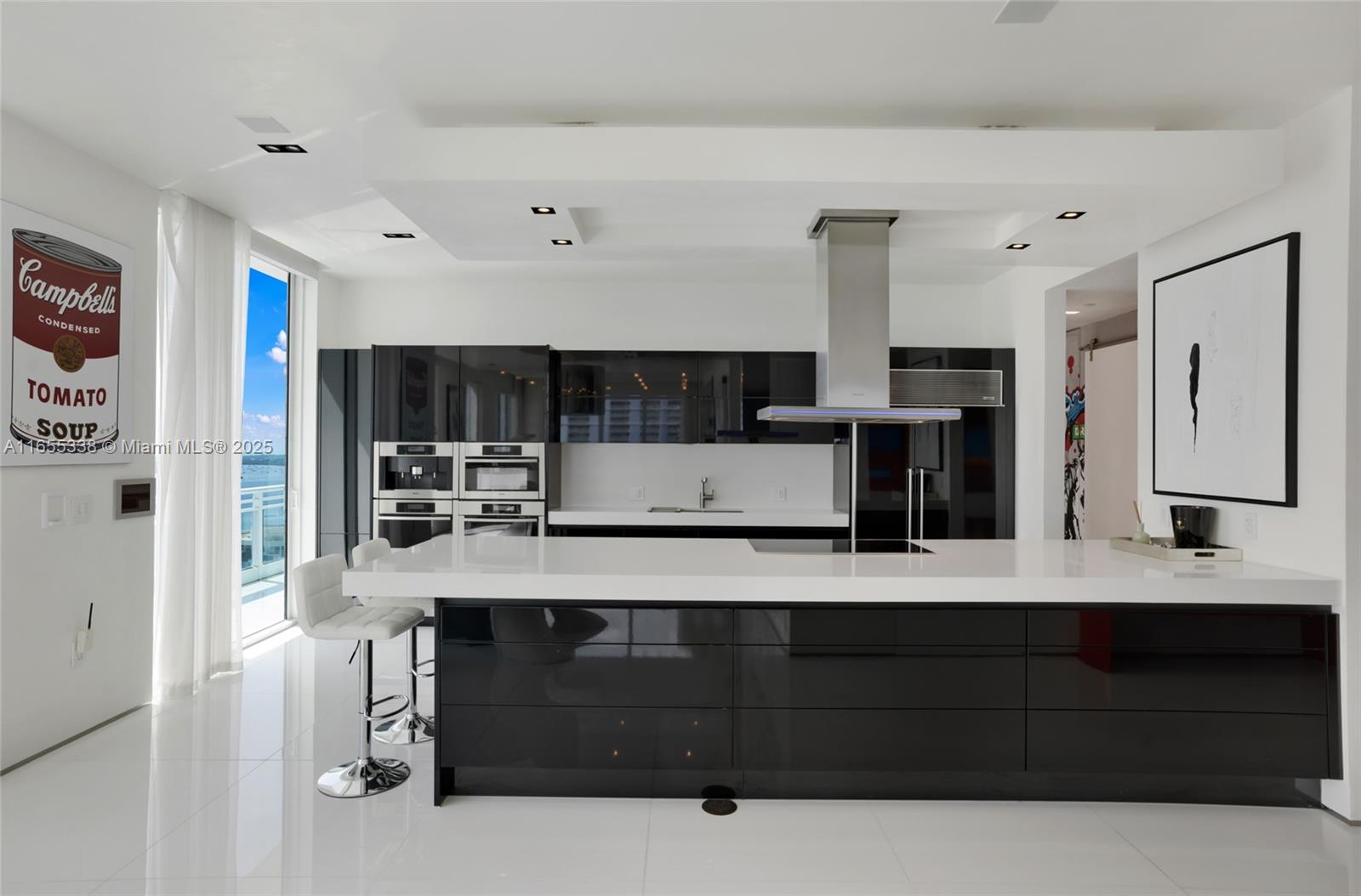 900 Brickell Key Boulevard, Unit 2603 Miami, FL 33131 - Photo 27 of 99 a living room with stainless steel appliances kitchen island granite countertop a refrigerator and cabinets