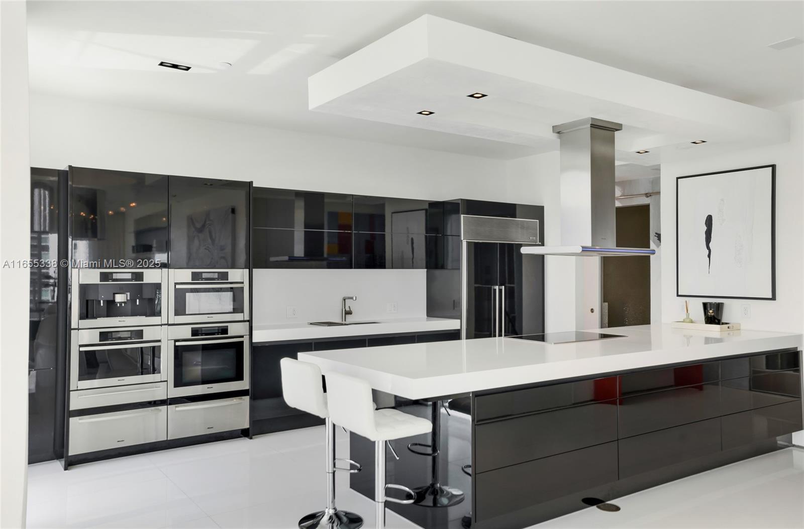 900 Brickell Key Boulevard, Unit 2603 Miami, FL 33131 - Photo 29 of 99 a kitchen with a stove and a refrigerator