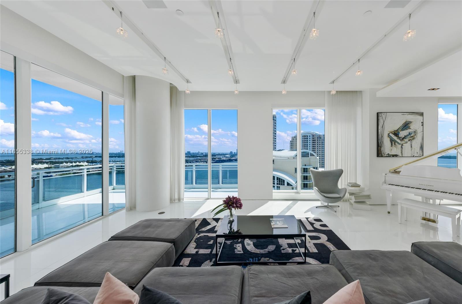 900 Brickell Key Boulevard, Unit 2603 Miami, FL 33131 - Photo 4 of 99 a living room with furniture and a large window