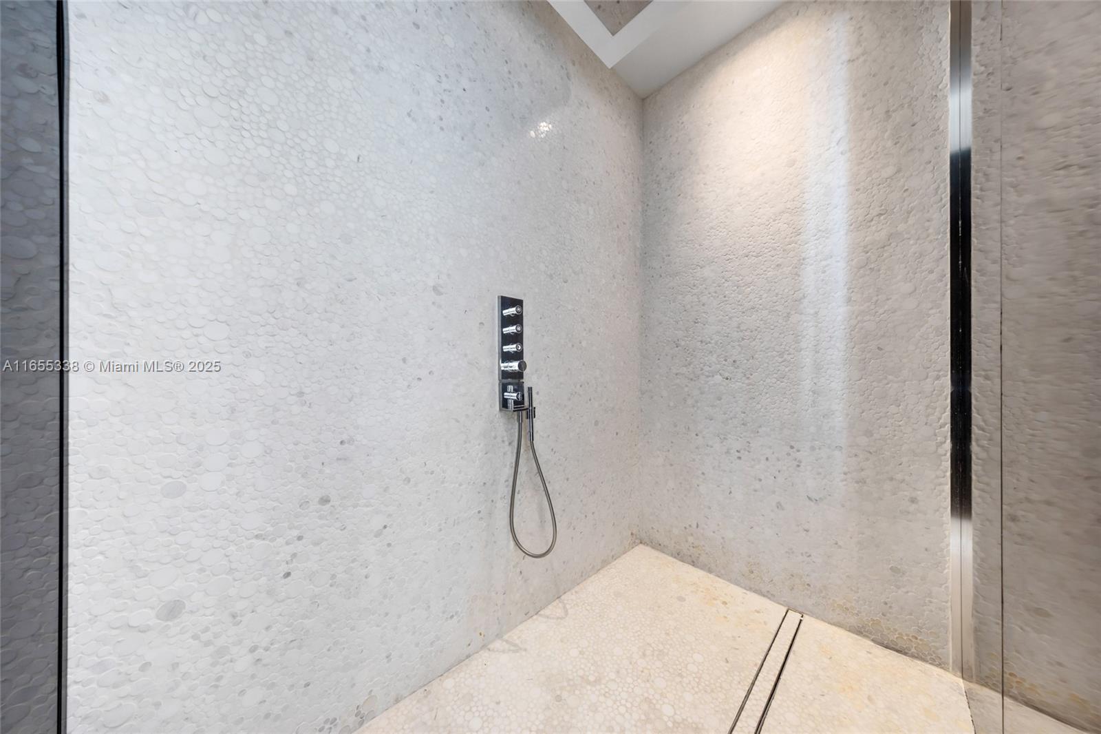 900 Brickell Key Boulevard, Unit 2603 Miami, FL 33131 - Photo 41 of 99 a bathroom with a glass shower door