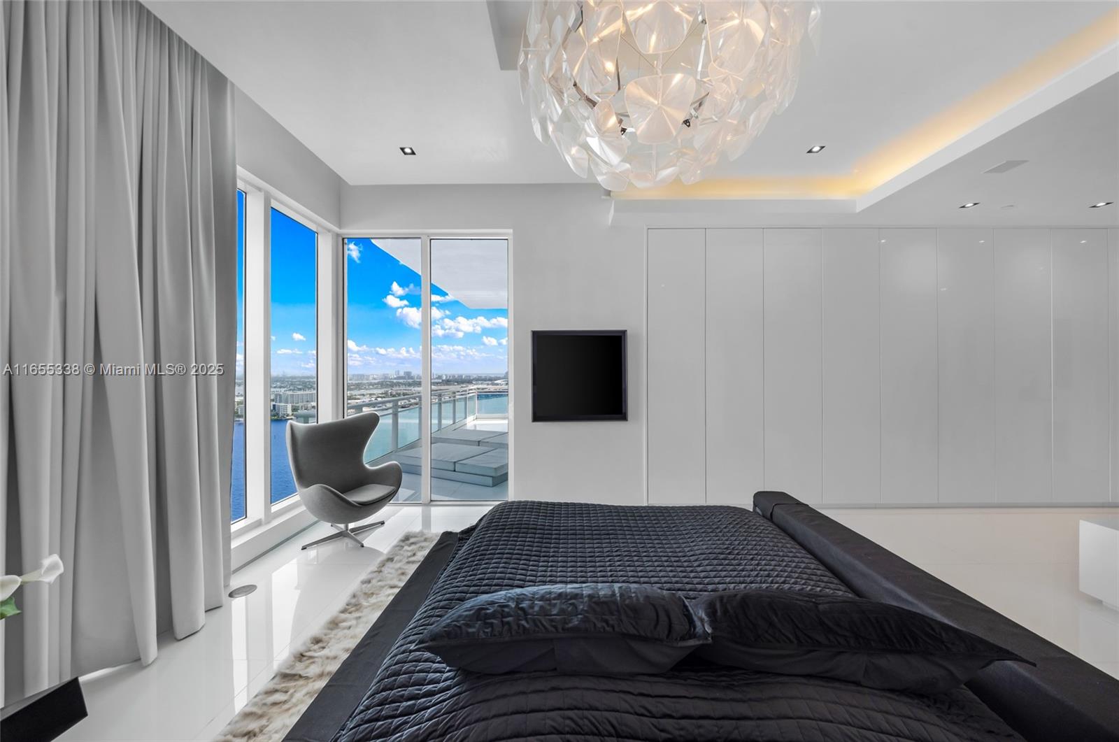 900 Brickell Key Boulevard, Unit 2603 Miami, FL 33131 - Photo 43 of 99 a bedroom with a large bed and a flat tv screen on dresser