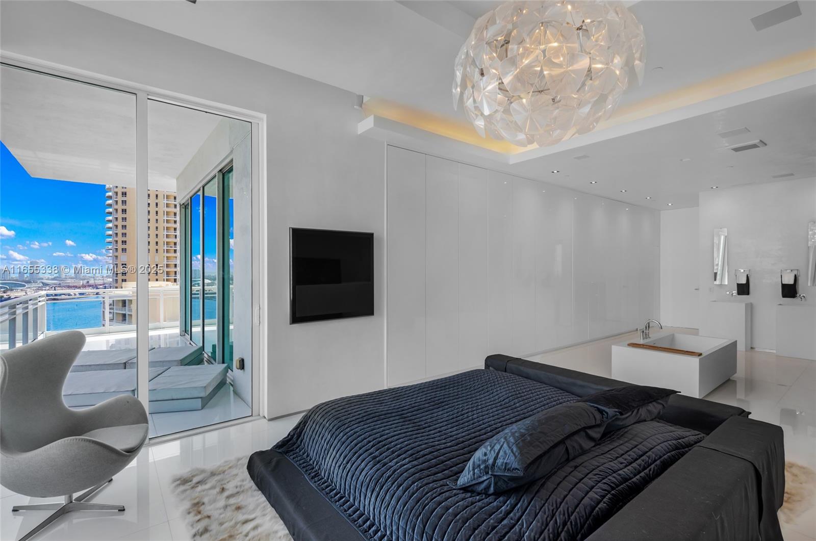 900 Brickell Key Boulevard, Unit 2603 Miami, FL 33131 - Photo 44 of 99 a bedroom with a large bed and a television