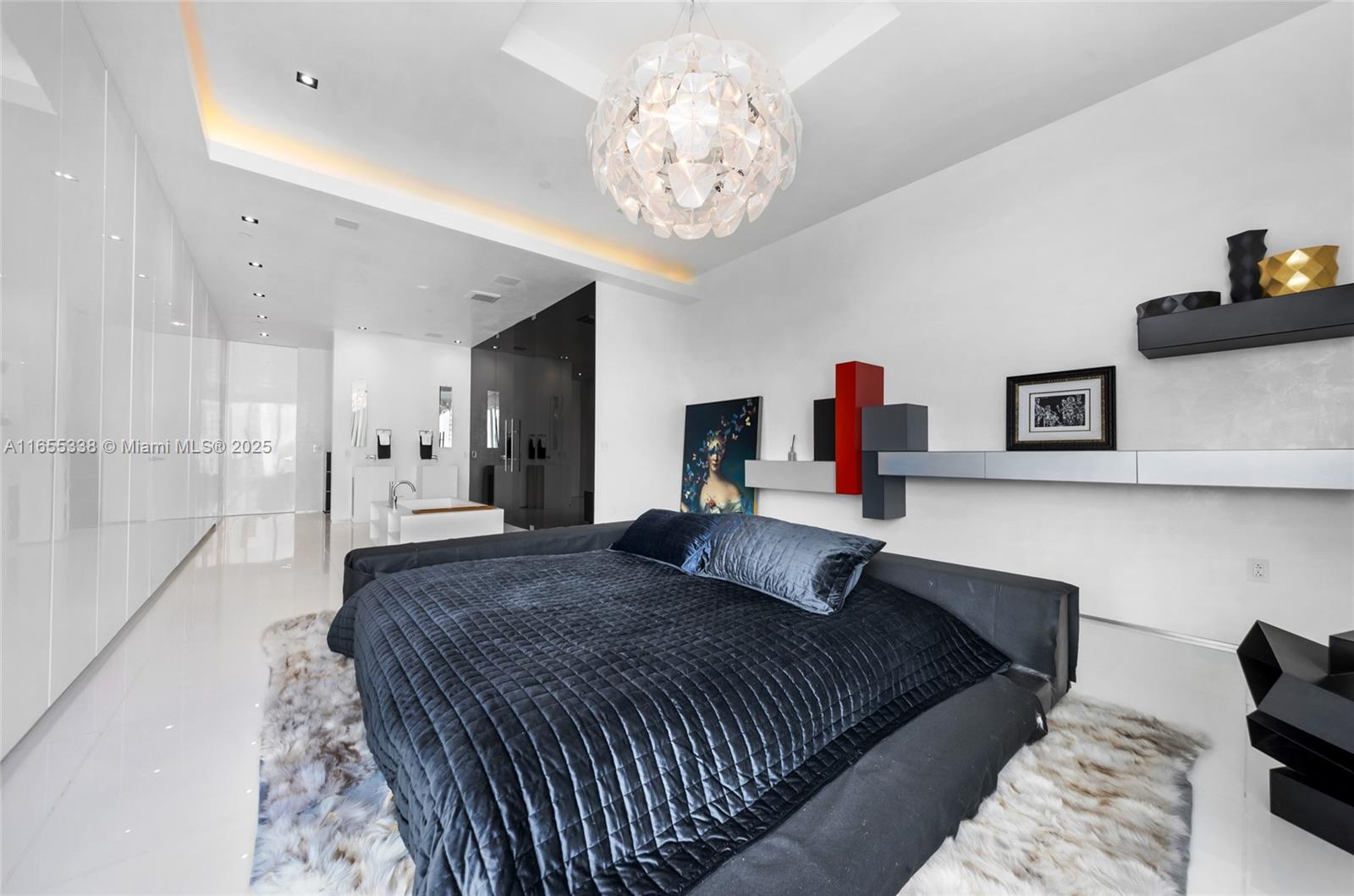 900 Brickell Key Boulevard, Unit 2603 Miami, FL 33131 - Photo 45 of 99 a bedroom with a bed and a chandelier