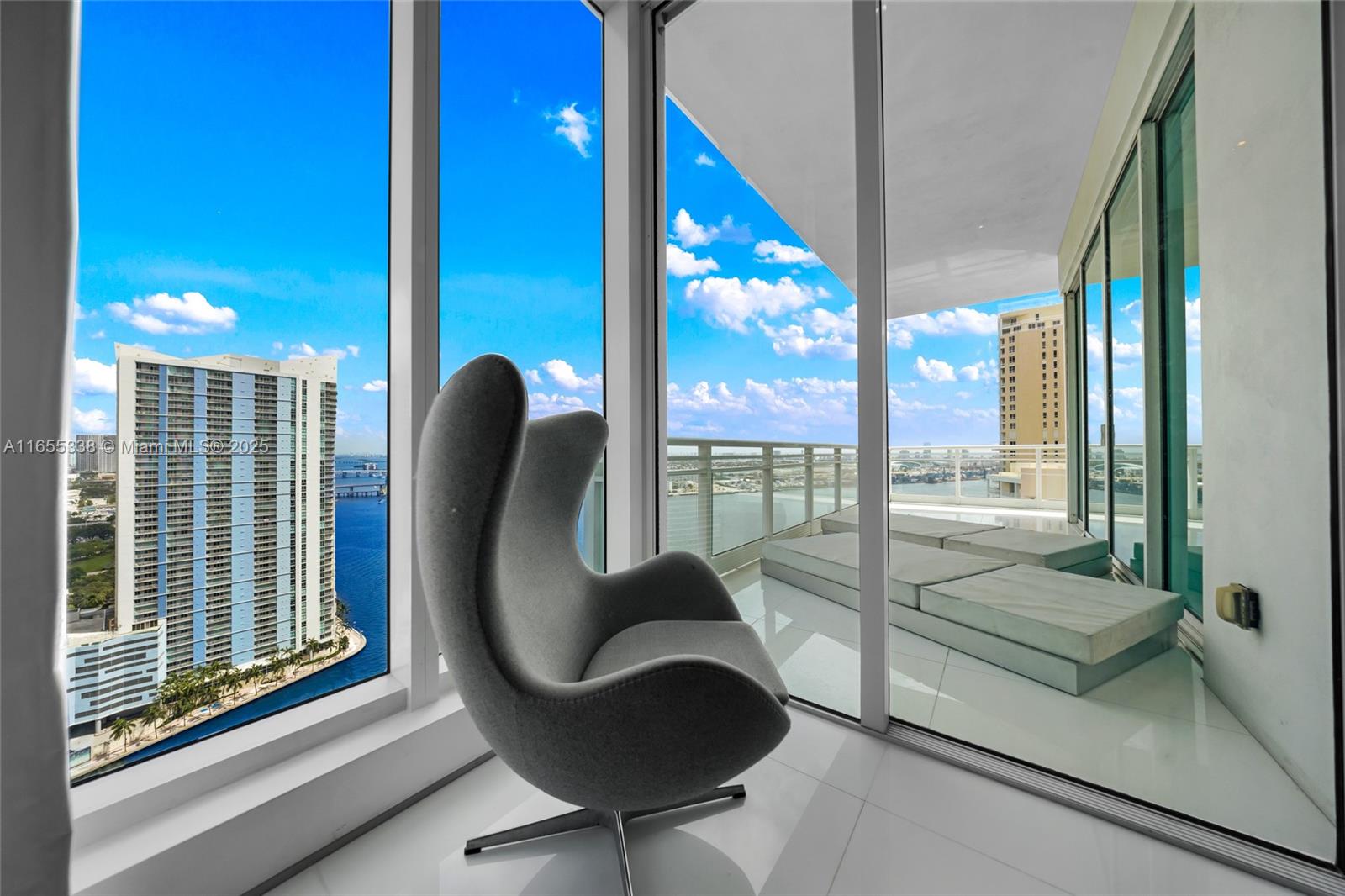 900 Brickell Key Boulevard, Unit 2603 Miami, FL 33131 - Photo 46 of 99 a living room with furniture and a large window