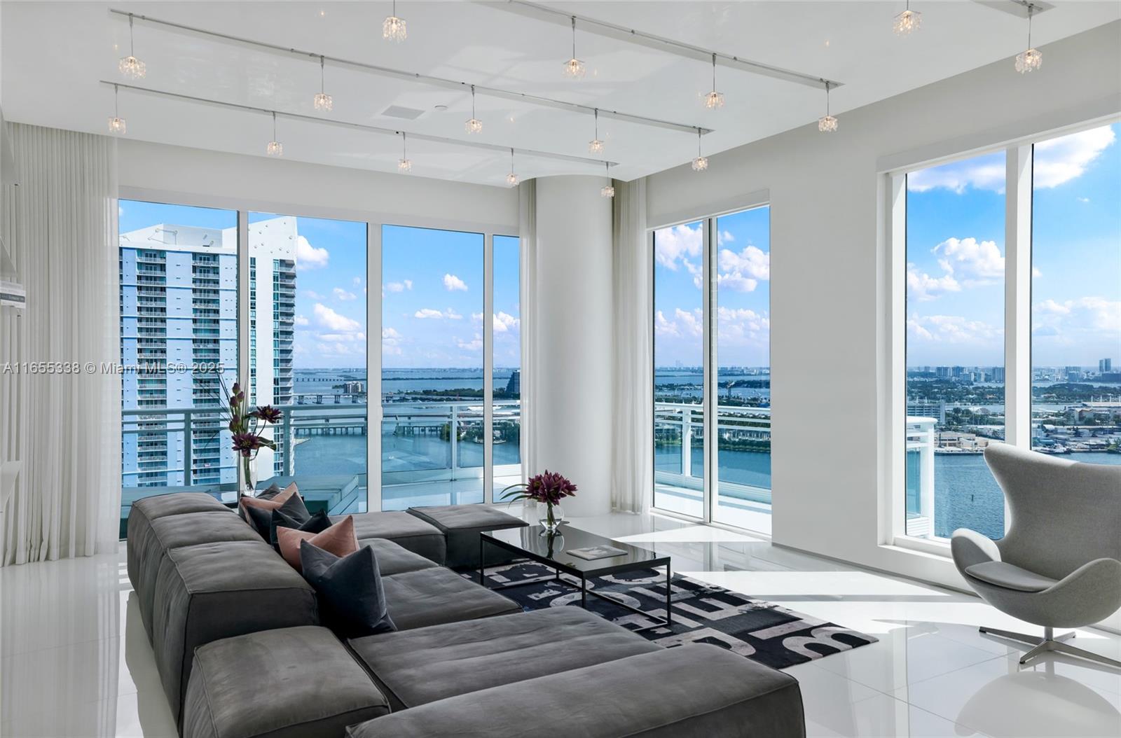 900 Brickell Key Boulevard, Unit 2603 Miami, FL 33131 - Photo 5 of 99 a living room with furniture and floor to ceiling windows