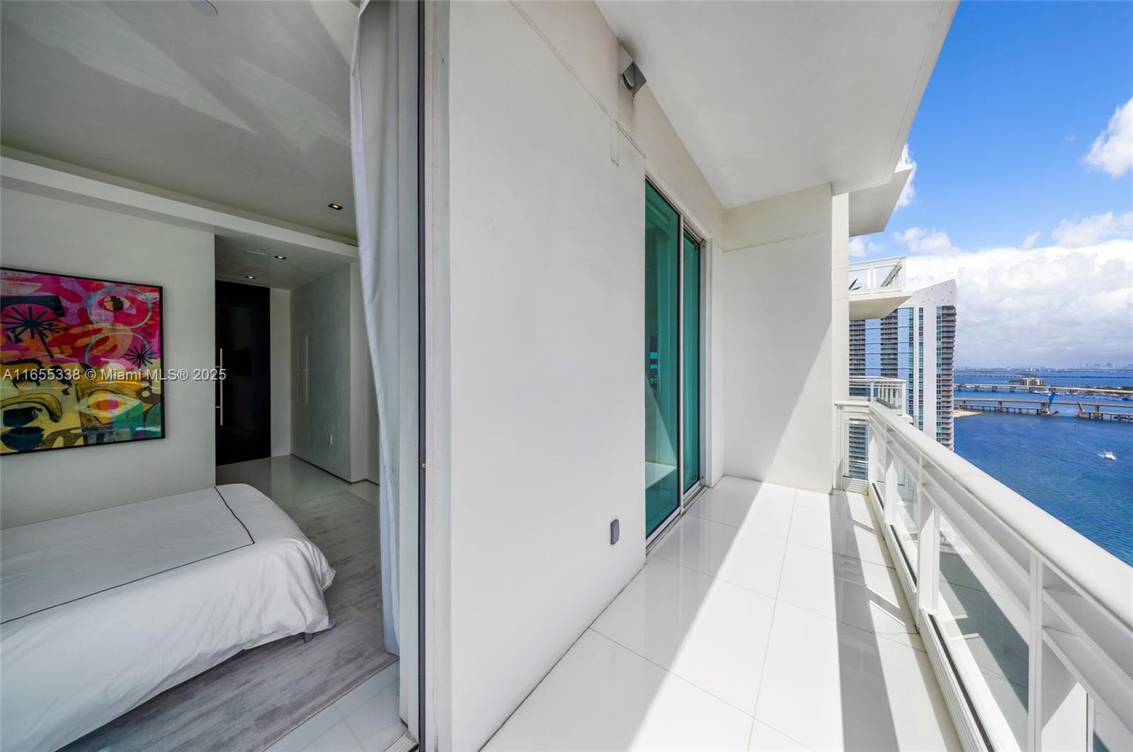 900 Brickell Key Boulevard, Unit 2603 Miami, FL 33131 - Photo 55 of 99 a view of a hallway with a large window and couch