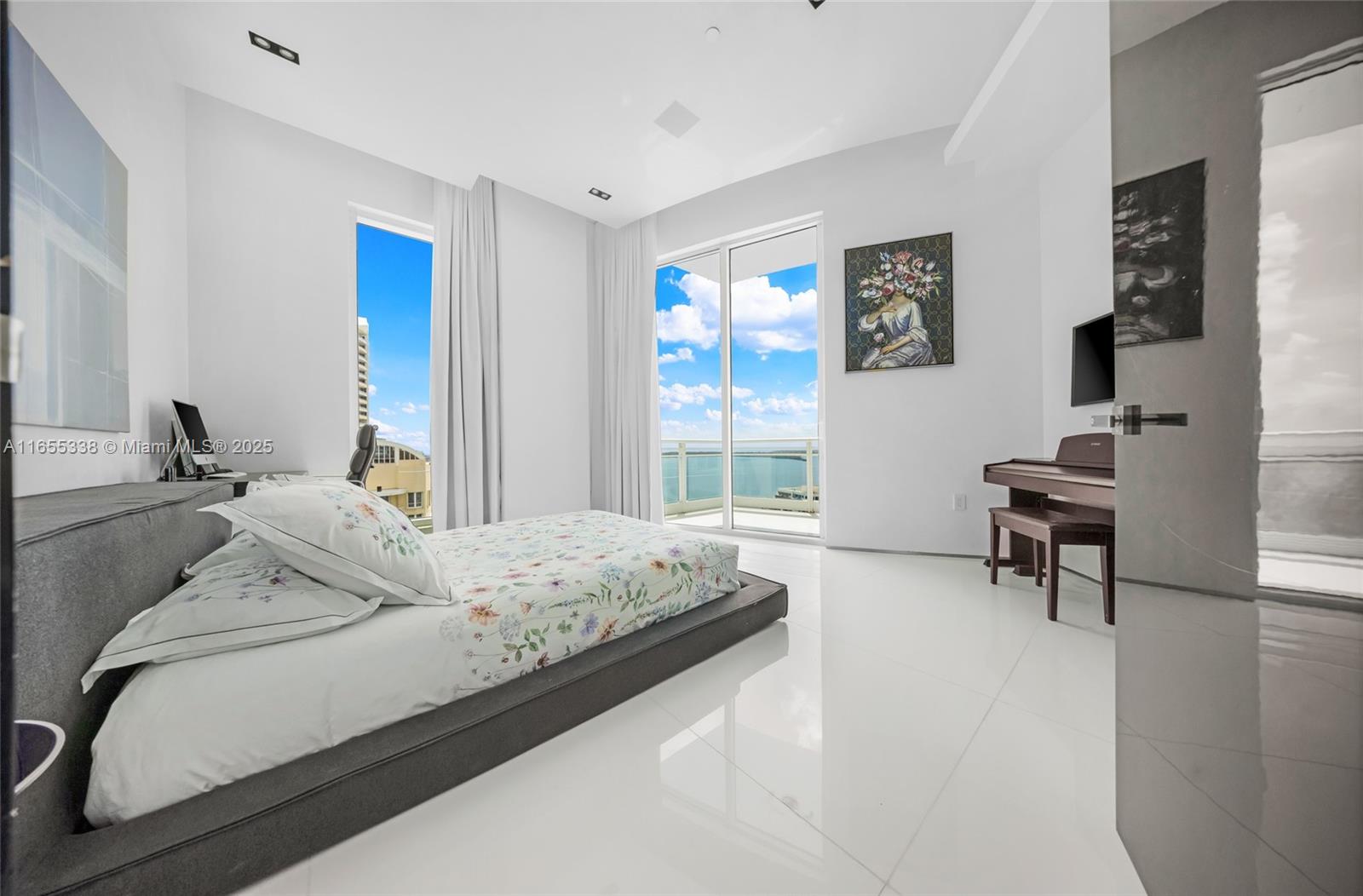 900 Brickell Key Boulevard, Unit 2603 Miami, FL 33131 - Photo 58 of 99 a bedroom with a bed and a chair in it