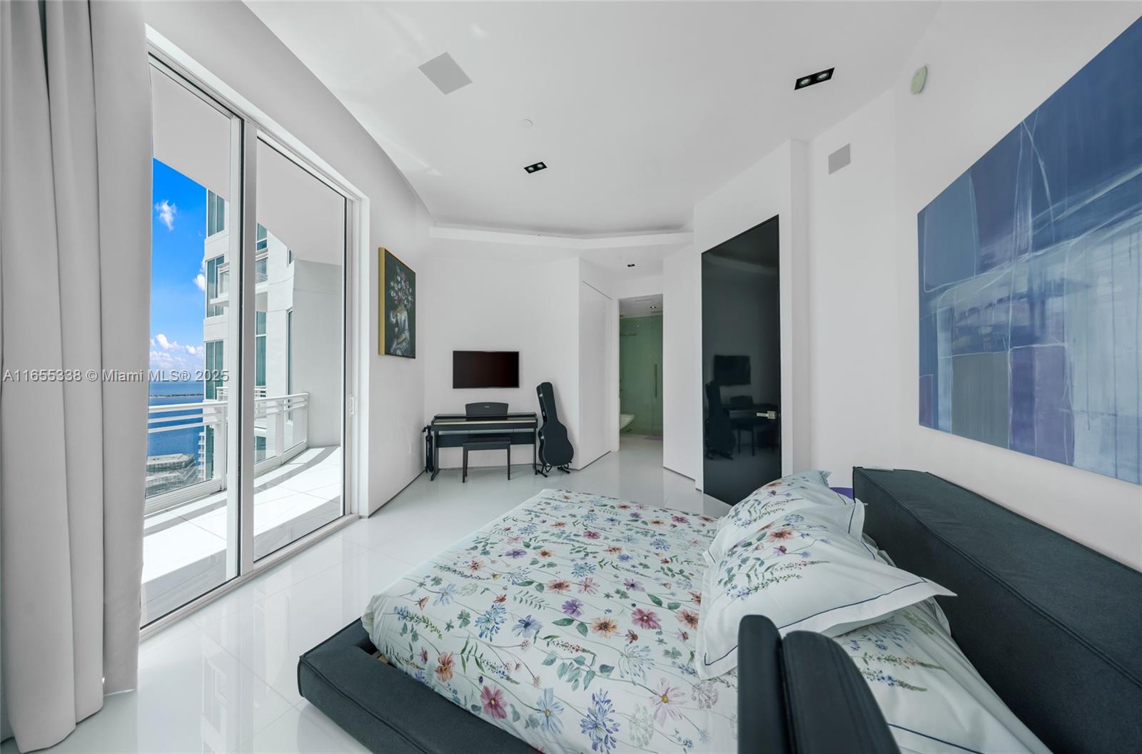 900 Brickell Key Boulevard, Unit 2603 Miami, FL 33131 - Photo 59 of 99 a bedroom with a bed and a television